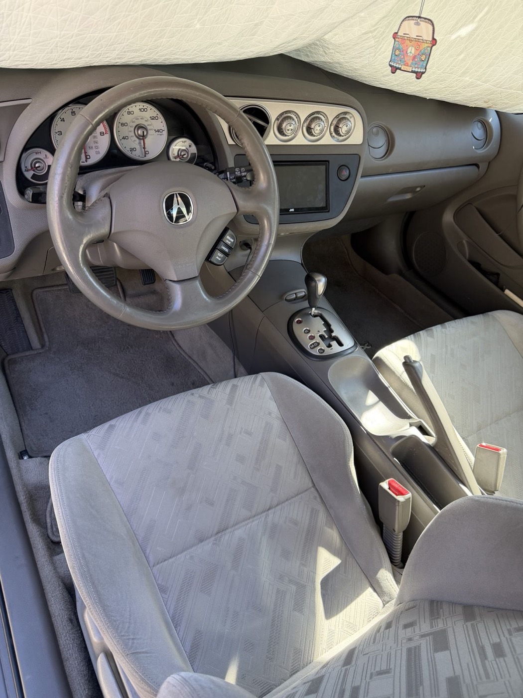 The RSX's original worn grey carpet floor mats
