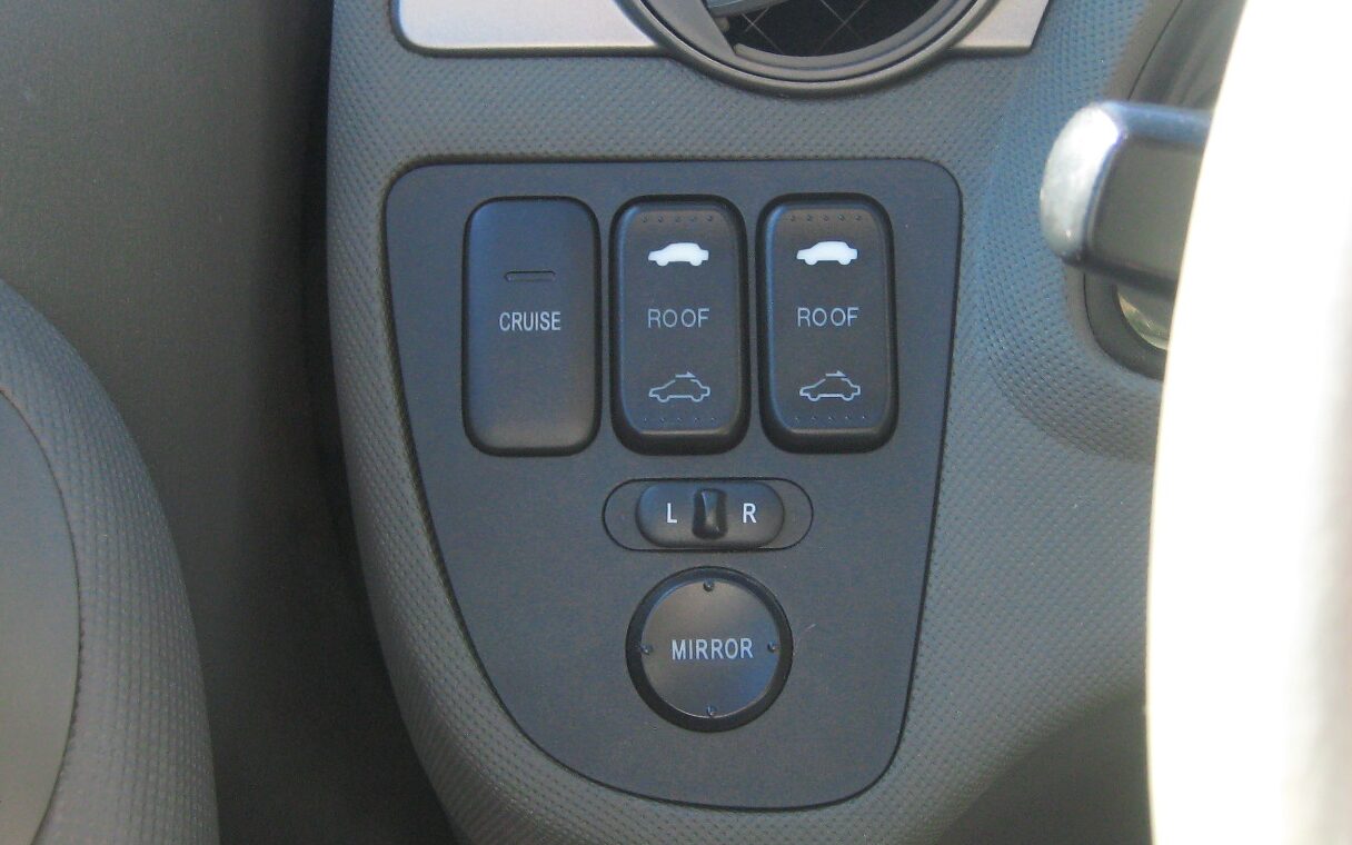 The sunroof switch installed as a volume control in the Acura's dashboard switch panel